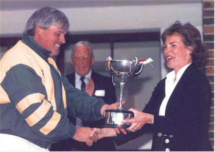 1998 Horsford skipper Steve Read receives the Carter Cup from Charlotte Carter 16th August 1998.  John Bettridge, Committee Member since 1971 Carter Cup organising Chairman 1990 - 